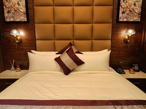 a bedroom with a large bed with a large headboard at Retrieve Health & Wellness in Cochin