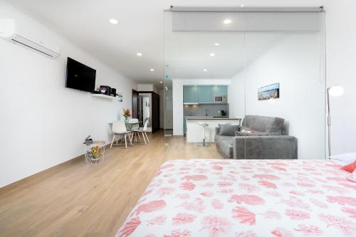 a bedroom with a bed and a living room at Apartamento Algarve, located center of Vilamoura in Quarteira