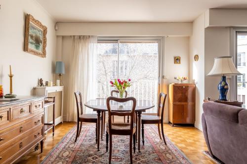 une salle à manger avec une table et des chaises et une fenêtre dans l'établissement Veeve - Fragments in Time, à Paris