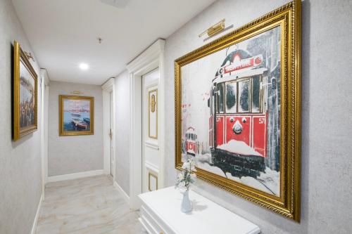 a hallway with a painting of a train on the wall at Leslion Luxury Hotel in Antalya