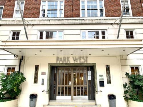 a building with the entrance to a park west building at Park West Apartment in London