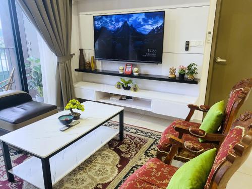 a living room with a tv on a wall at Lovely Mines Astetica Lake View Seri Kembangan 2BR in Seri Kembangan