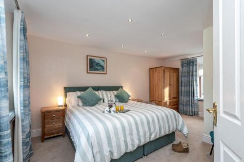 a bedroom with a large bed with a nightstand and a bed sidx sidx sidx at 40 Church Street in Aberffraw