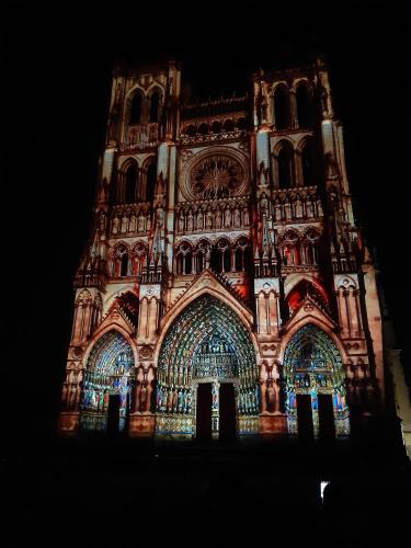 a building with a lit up facade at night at 14-18 Somme Chambres in Beaucourt-sur-lʼAncre