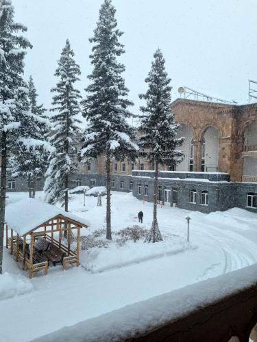 a courtyard covered in snow in front of a building at Jermuk Moscow Health Resort in Jermuk
