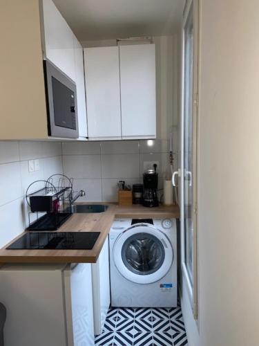 a kitchen with a washing machine in a kitchen at LE COSY de Saint-Denis in Saint-Denis