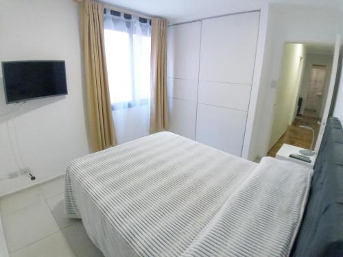 Una cama o camas en una habitación de Amplio Departamento 2 Dormitorios Nueva Córdoba