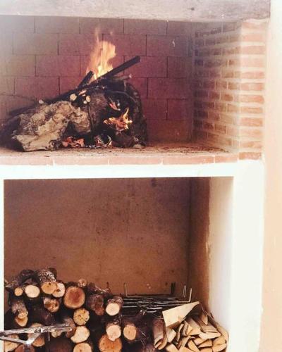 a brick oven with a fire in it at Casa Rural con encanto Señorio Manchego ALBACETE in Yeste