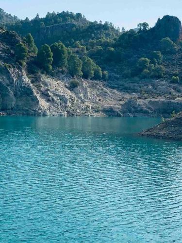 a large body of water next to a mountain at Casa Rural con encanto Señorio Manchego ALBACETE in Yeste