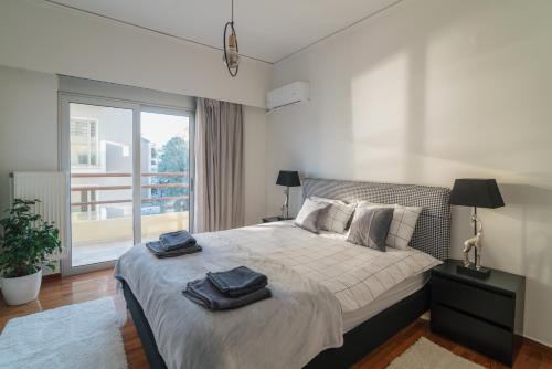 a bedroom with a large bed with towels on it at Sea Front Luxury Apartment in Patra