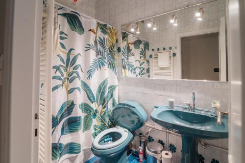 a bathroom with a sink and a toilet and a mirror at Sea Front Luxury Apartment in Patra