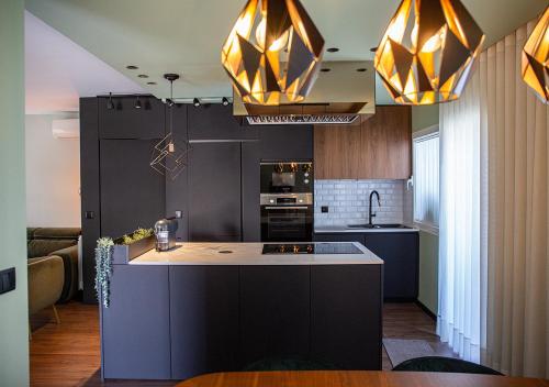 a kitchen with a large island in the middle at Thyrso Village in Santo Tirso