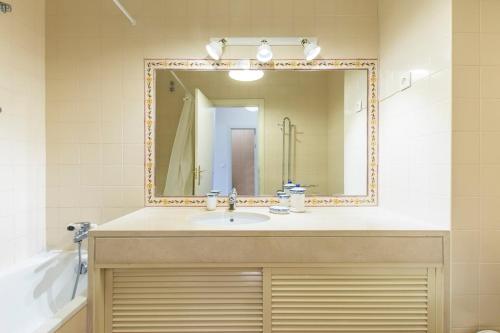 a bathroom with a sink and a mirror at Apartment Anibal in Aroeira