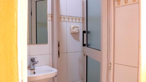 a bathroom with a sink and a mirror at Eton Hotel in Thika