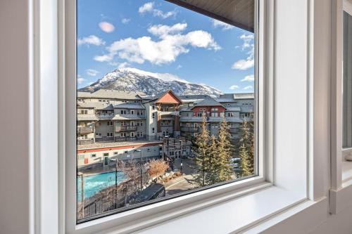 a window with a view of a mountain at Mountain Retreat - Modern and Bright with Panorama Views 2 bedrooms, 4 beds, heated all-year outdoor pool, hottub, balcony, Banff Park Pass in Canmore