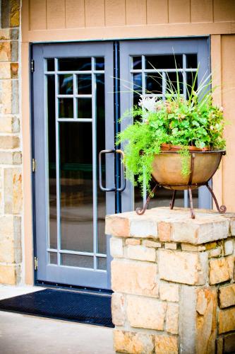 a potted plant on a stone wall in front of a door at POSTOAK Lodge and Retreat in Tulsa