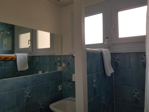 a bathroom with a tub and a sink and a mirror at Le Chabi in La Chapelle-dʼAbondance