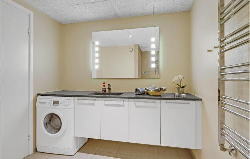 a white laundry room with a sink and a washing machine at Amazing Home In Ringkbing With 3 Bedrooms And Wifi in Søndervig