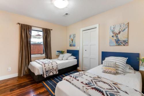 a bedroom with two beds and a window at City Center Sanctuary in Estes Park