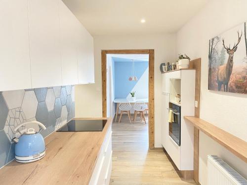 a kitchen with white cabinets and a dining room at Appartement thématique: Nature Scandinave in Travers