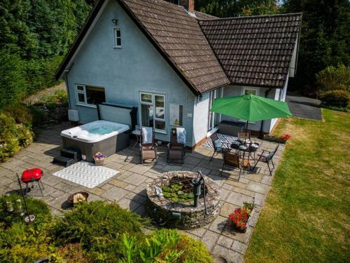 an aerial view of a house with a patio and a hot tub at A spacious hidden gem with hot tub, lovely garden & views in Kington