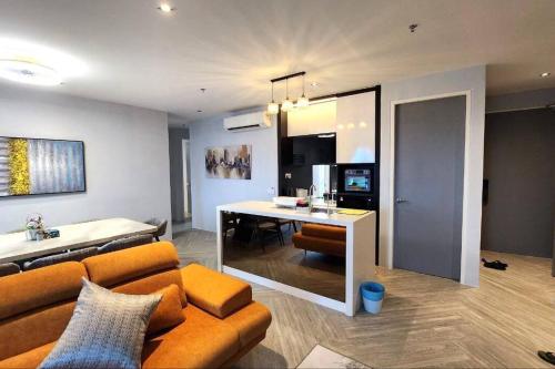 a living room with a couch and a dining room at Lumi Tropicana, Petaling Jaya 01 Golf View in Petaling Jaya