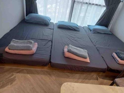 two twin beds in a room with a window at Lumi Tropicana, Petaling Jaya 01 Golf View in Petaling Jaya