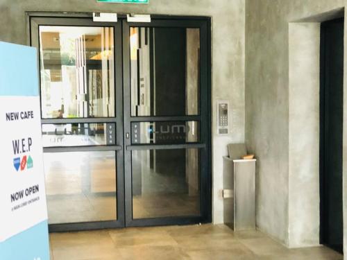 a large glass door in a building at Lumi Tropicana, Petaling Jaya 01 Golf View in Petaling Jaya
