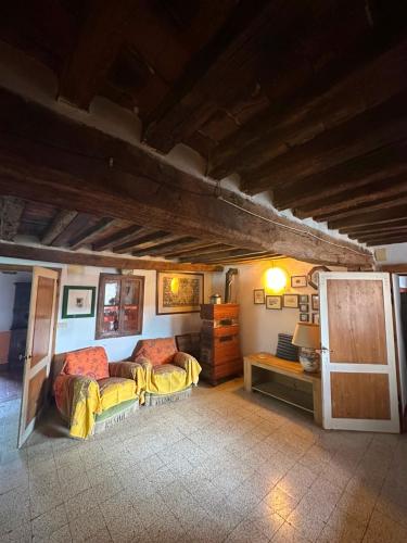 a living room with two beds and a table at La casa nel Castello in Canneto