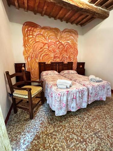 a bedroom with two beds and two chairs at La casa nel Castello in Canneto