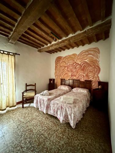 a bedroom with two beds and a large wooden headboard at La casa nel Castello in Canneto