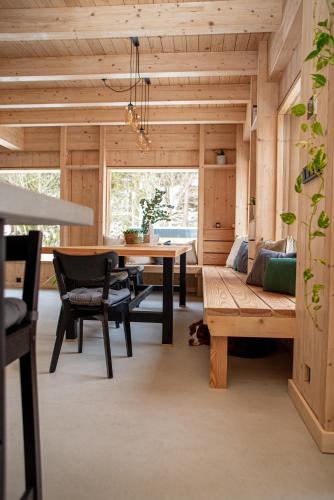 a room with a table and a couch and a dining room at VagusBouda/ &Fogo in Loučná nad Desnou