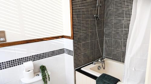a bathroom with a toilet and a sink at Leamington Spa Warwick Place Apartments in Leamington Spa