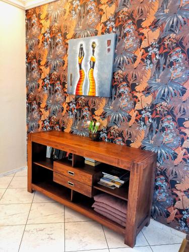 a living room with a table and a wall at Villa Wellness in Budapest