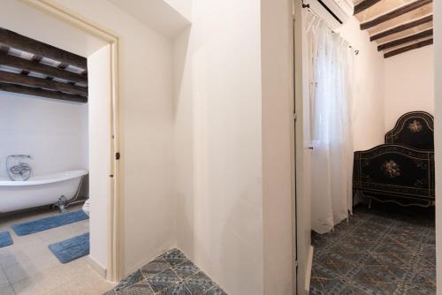 a bathroom with a tub and a toilet and a sink at Antica Fortezza Villa Fontana in Valderice