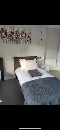 a bedroom with a bed and a painting on the wall at The Station Restaurant & Bar in Doncaster