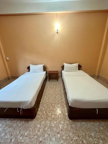 Postel nebo postele na pokoji v ubytování Phaythavone Hotel