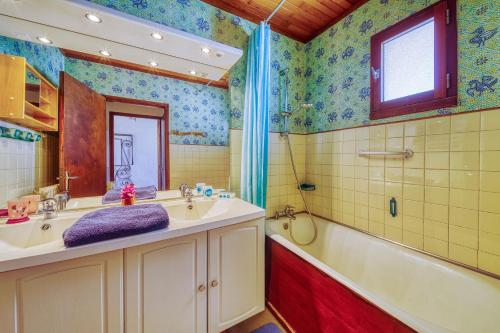 a bathroom with a tub and a sink and a bath tub at Chalet les Colchiques in La Toussuire