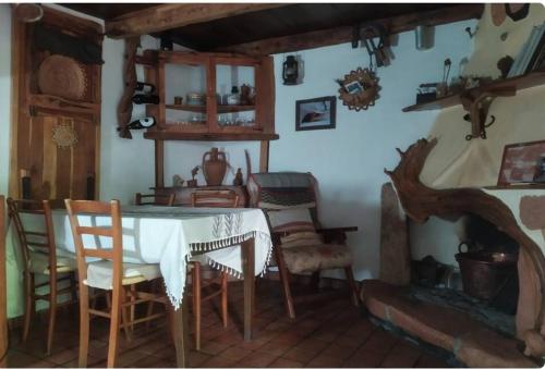 a dining room with a table and chairs at Sa domu 'eccia in Urzulei