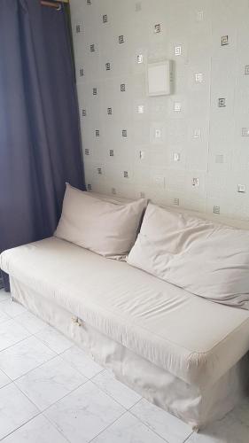 a bed with white sheets and pillows in a room at Apartamento Relax in Arona