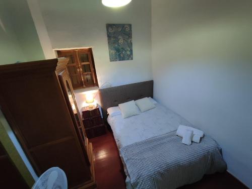 a small bedroom with a bed with two pillows on it at Apartamento con zona chill-out y preciosas vistas in Granada