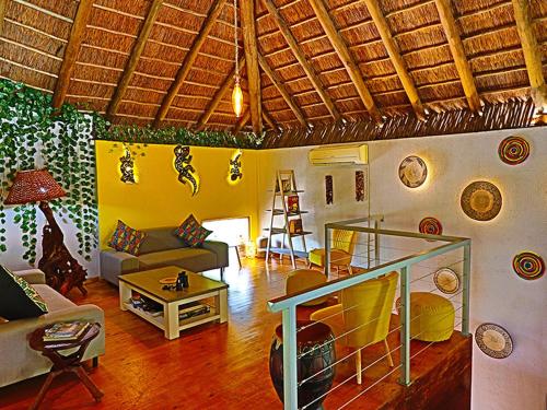Kruger Park Hostel في مارلوث بارك: غرفة معيشة مع أريكة وطاولة