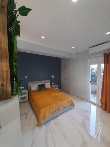 a bedroom with a large bed with orange bedspread at Salavantes House in Chania Town