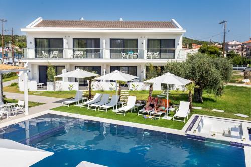 a villa with a swimming pool and a house at Epicentrum Suites in Limenaria