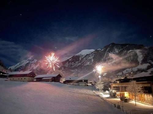 a firework display in front of a mountain at night at Appartement Wälderhof in Kaprun