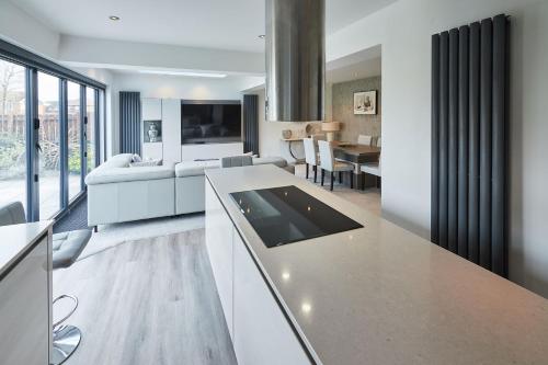 a kitchen and living room with a tablet on a counter at Host & Stay - Benton Road in Newcastle upon Tyne