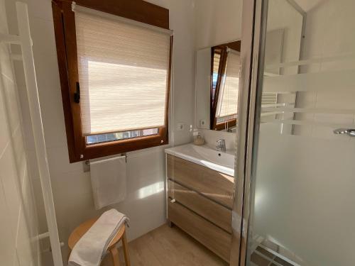 a bathroom with a shower and a sink and a mirror at la casita de oruña in Oruña