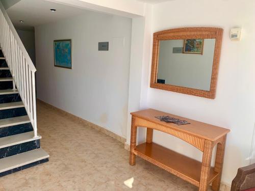 a room with a table and a mirror on the wall at Hospedium Hotel Continental in Mojácar