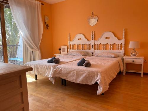 a bedroom with two beds with stuffed animals on them at Parque Holandés Fuerteventura casa Mayte in La Oliva
