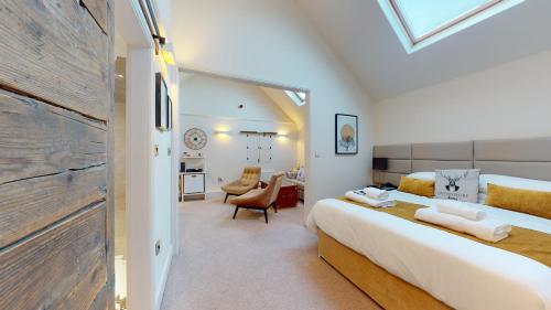 a bedroom with a large bed and a living room at The Devonshire Arms in Eckington